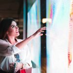A woman touching an indoor led display
