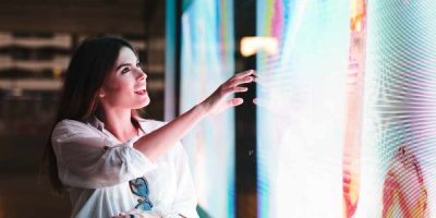 A woman touching an indoor led display