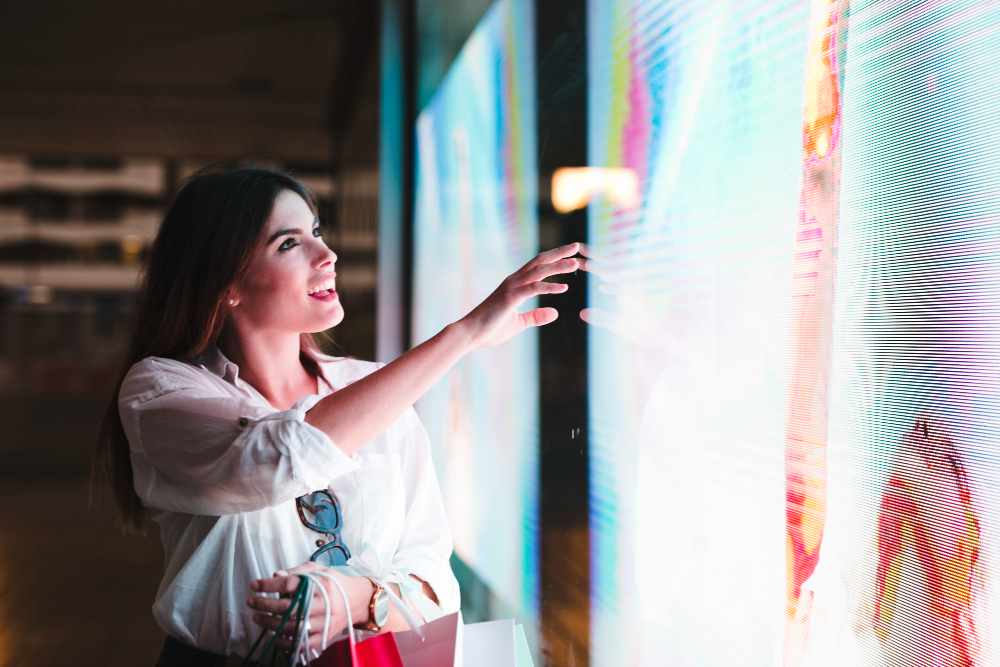 A woman touching an indoor led display