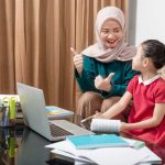 A young girl school student is learning from her tutor