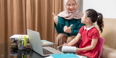 A young girl school student is learning from her tutor