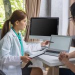 An interventional radiologist checking patient report (illustration)