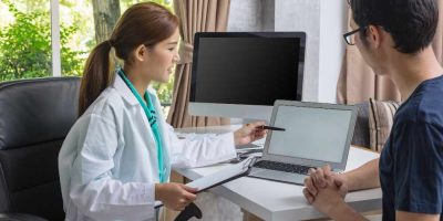 An interventional radiologist checking patient report (illustration)