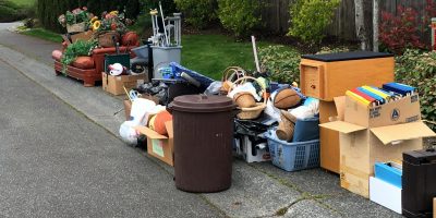 Large pile of assorted household junk and furniture placed on a suburban curbside for junk removal services Kent WA.
